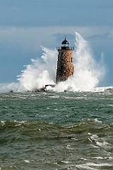 Huge Waves Surround Stone Whaleback Lighthouse Tower in Maine